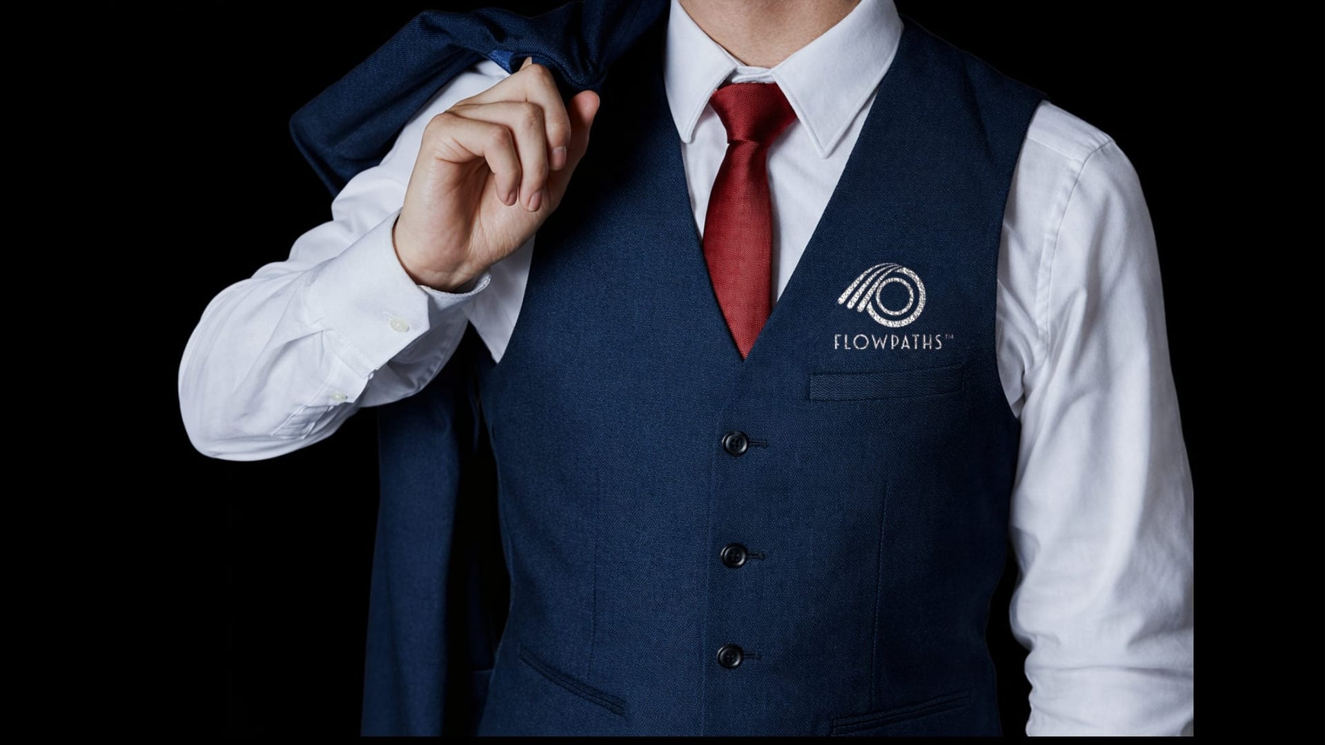 Navy vest with the Flowpaths mark embroidered on the chest