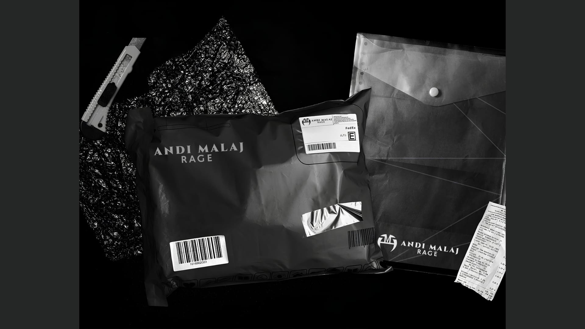Black mailer bag and document sleeve branded Andi Malaj Rage